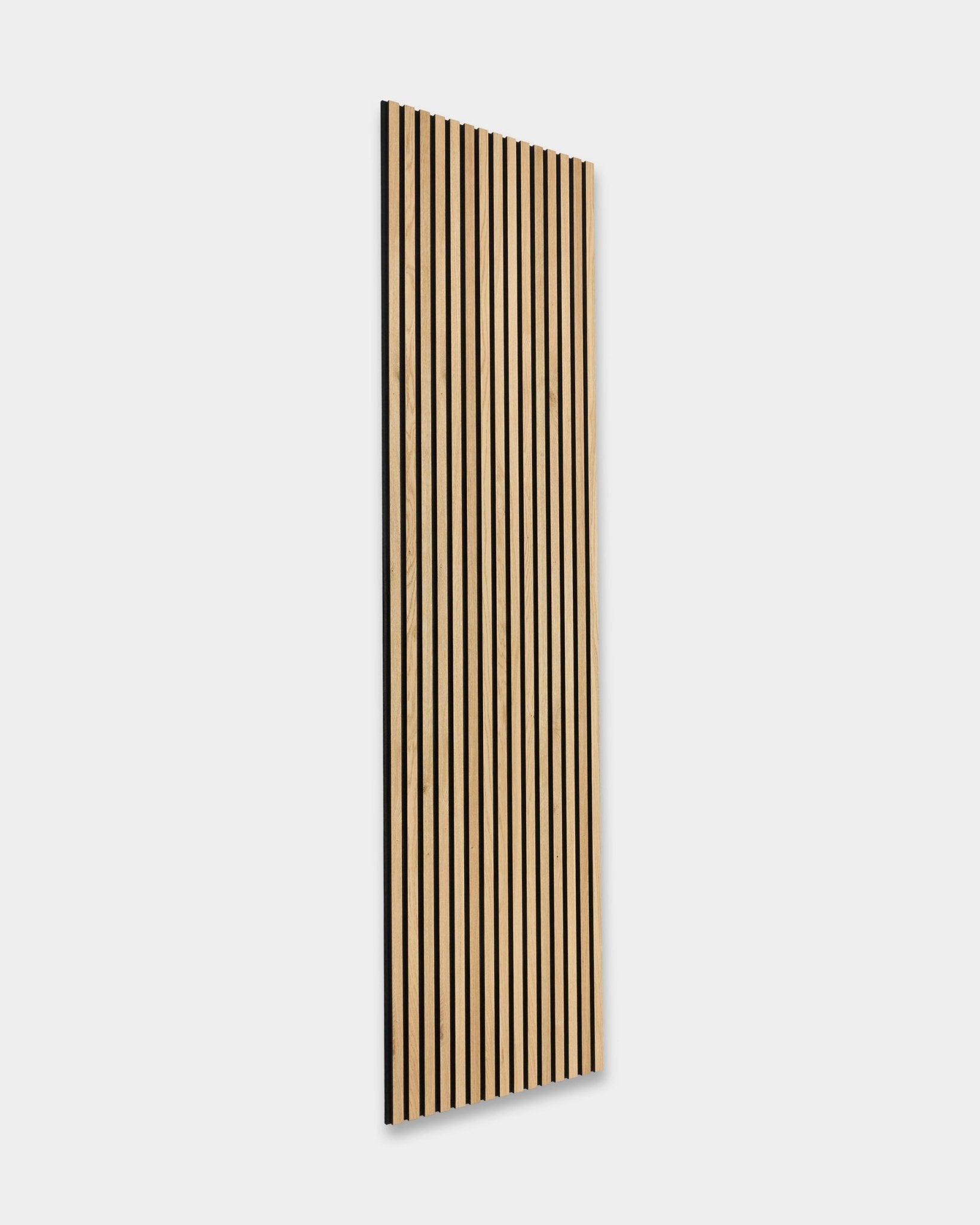 WoodUpp Akupanel in Natural Oak, 240x60 cm: Scandinavian acoustic panel with vertical black slats, mounted on a white wall. Nordic minimalist design.
