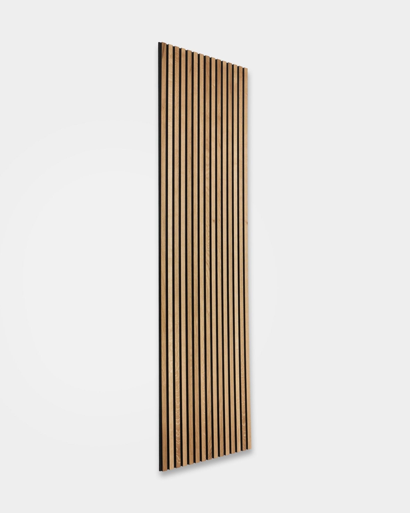 WoodUpp Akupanel Rustic in Brown Oak (240 x 60 cm) with vertical wooden slats and dark acoustic gaps, installed on a plain white wall for Nordic sound control.