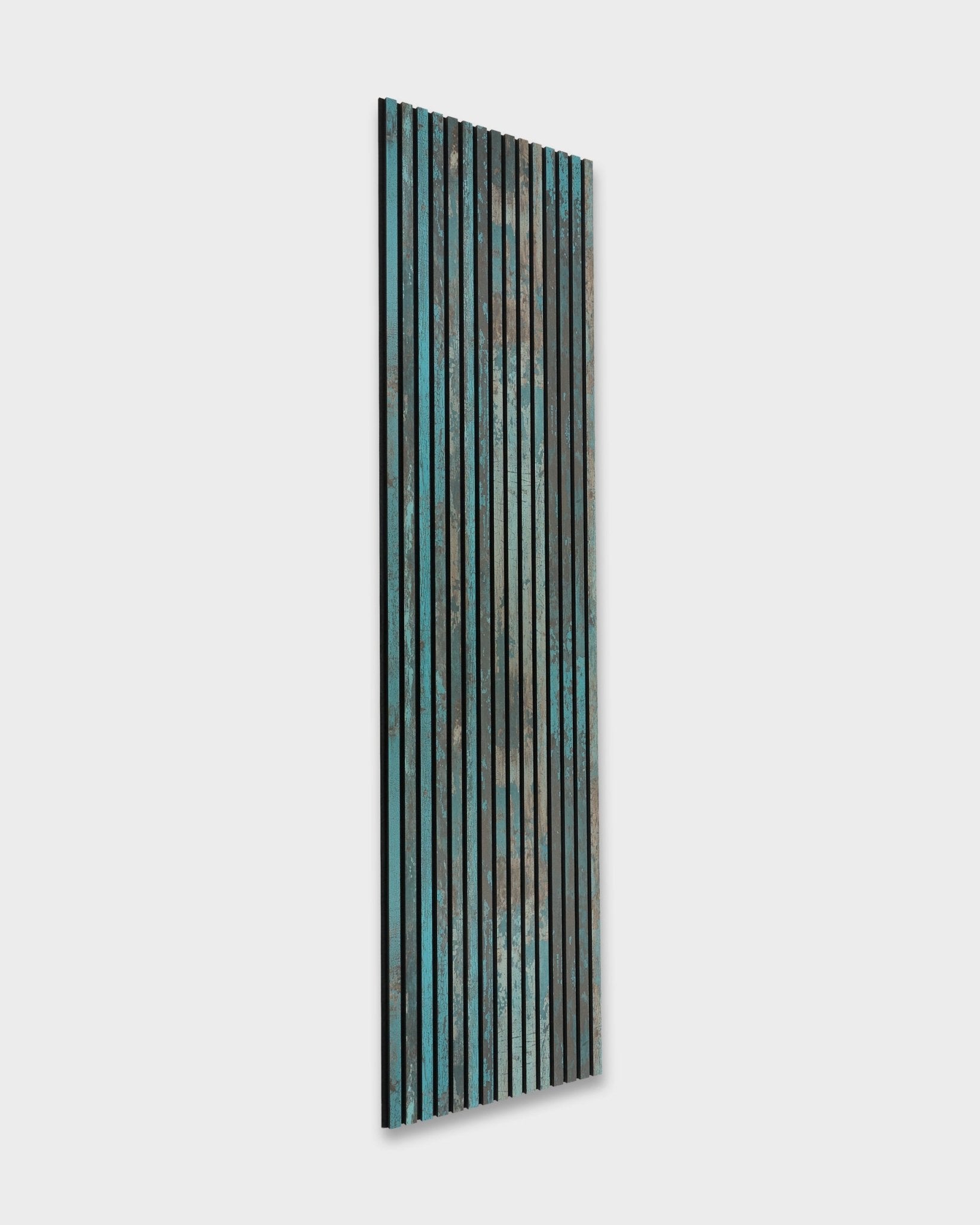 WoodUpp Akupanel Rebel in Oxide Blue (240x60 cm), a Nordic acoustic panel featuring vertical wood slats in blue, green, and brown.