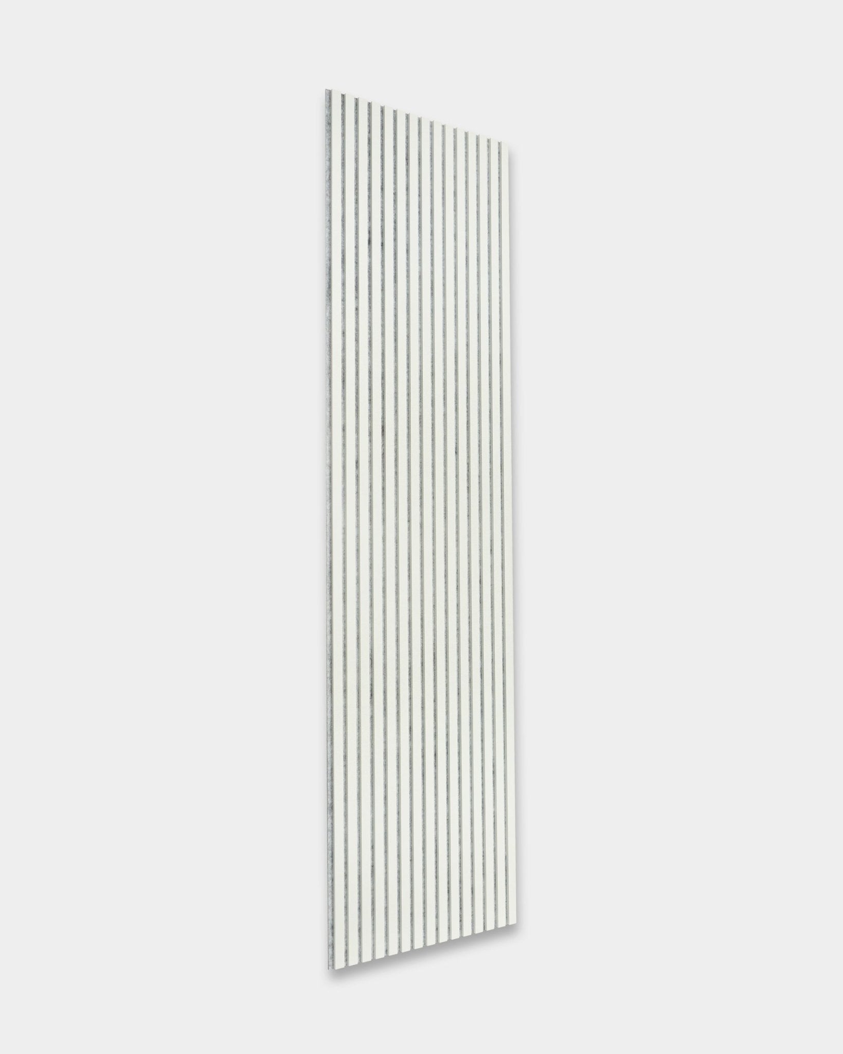 Akupanel Snow by WoodUpp, a white acoustic slatwall panel with black grooves (240 x 60 cm), mounted on a light gray wall for sound enhancement.