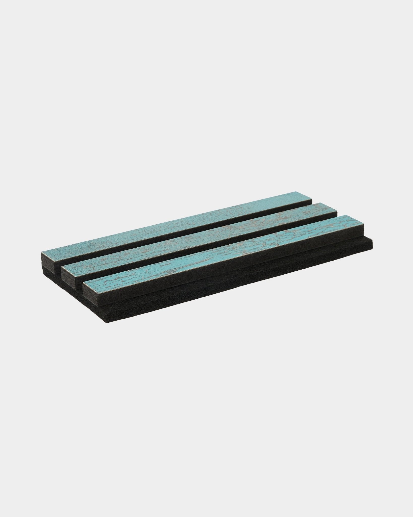 Three Blue Oxide Rebel foam pads from WoodUpp are stacked in parallel on a clean, white surface; designed as acoustic accessories for Nordic interiors.