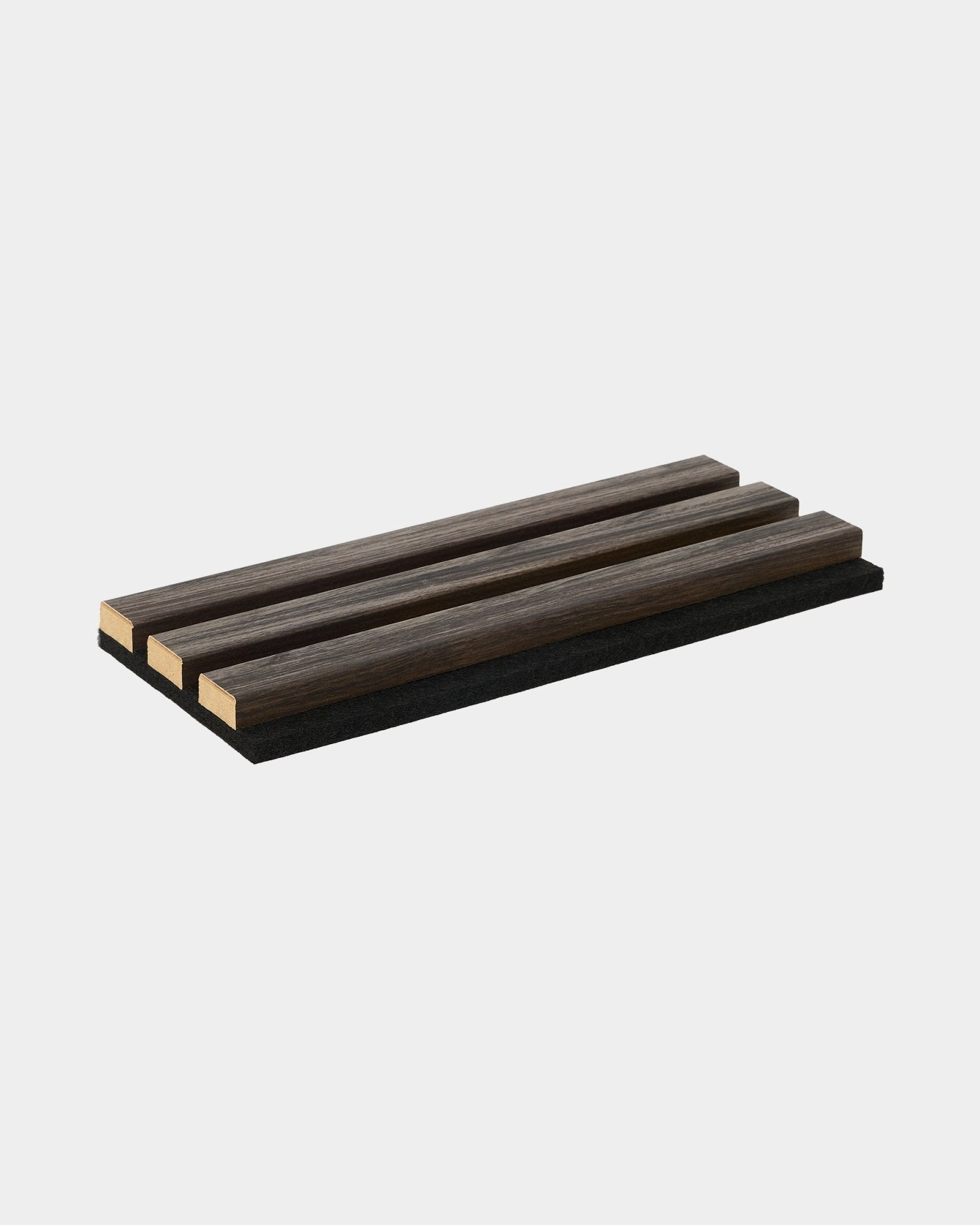 WoodUpp Essential Sample in Black Oak, a rectangular trivet accessory with three wooden slats, designed to complement Nordic acoustic wood panel collections.