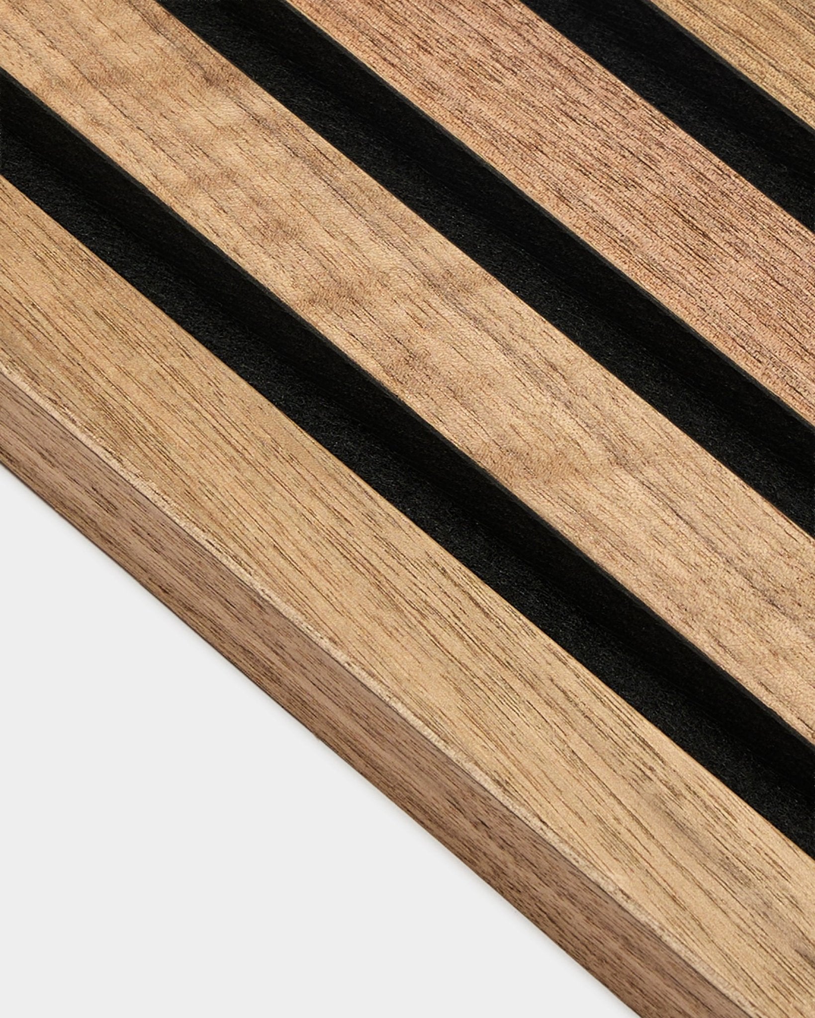 Close-up of WoodUpp Akupanel End Lamella in walnut, 2.2 cm acoustic panel featuring parallel black stripes and visible walnut wood grain on white background.