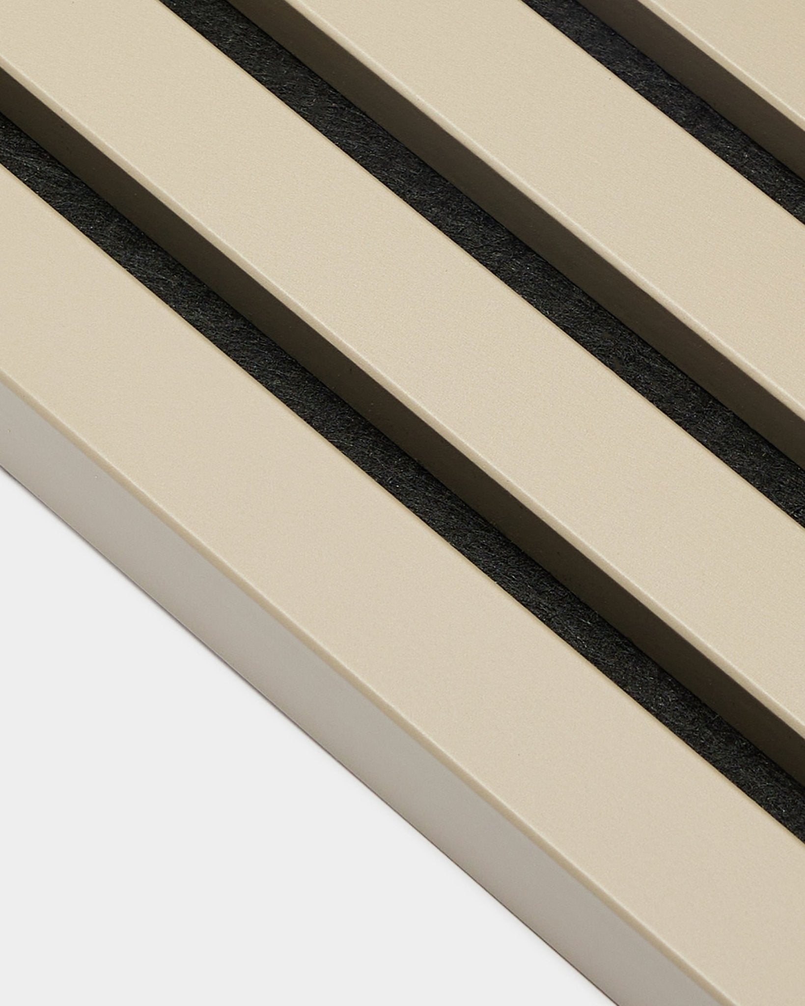 Close-up of WoodUpp Akupanel End Lamella in Stone, 2.2 cm—beige acoustic slats with black gaps on white backing, suitable for MDF frame panel walls.