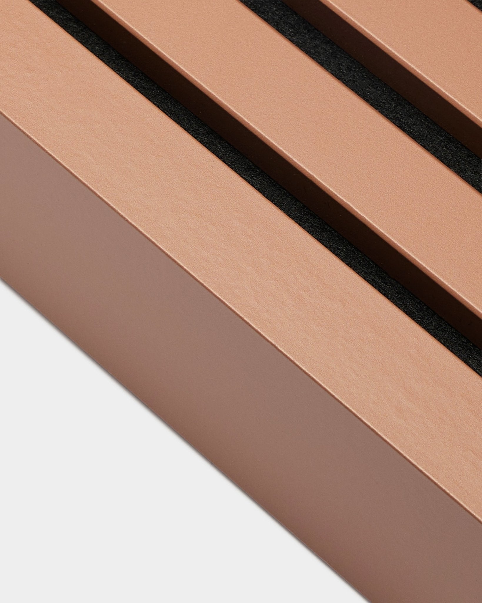 Close-up of WoodUpp Akupanel installation end lamella in Clay, 6.7 cm—light brown acoustic panel with three black slits, Nordic minimalist design.
