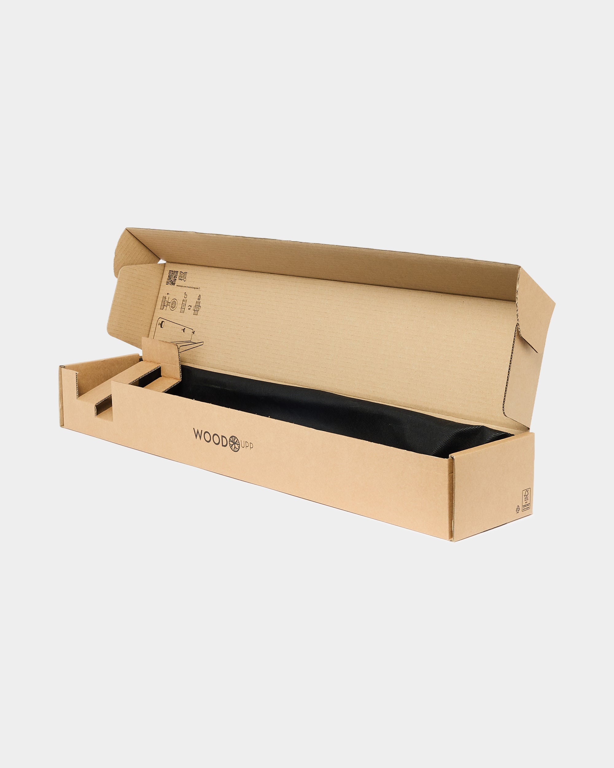 Open cardboard shipping box labeled WOODUP containing a black acoustic panel, placed on a plain white background.