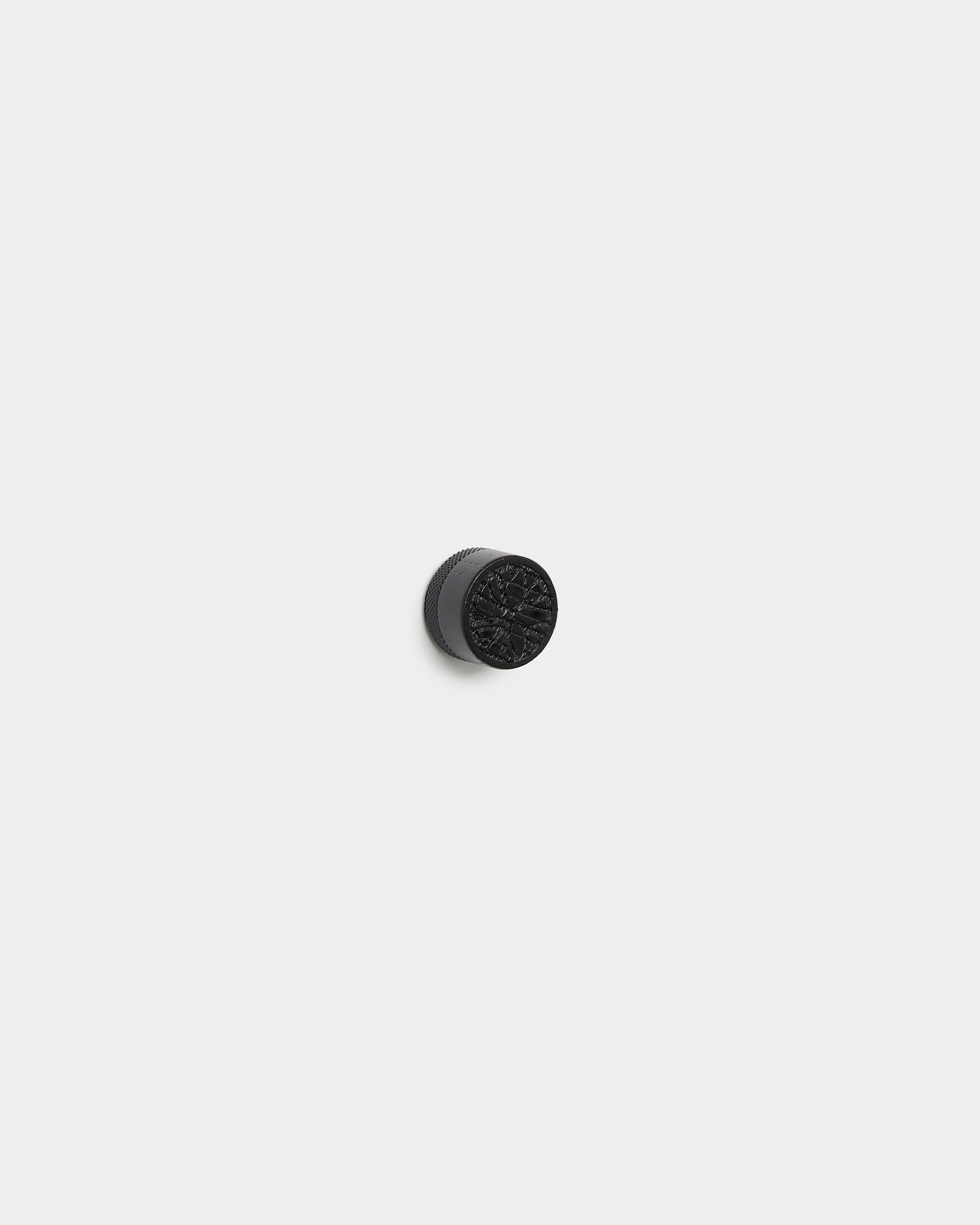 Norr Poster Magnet set by WoodUpp with small, round black oak knobs for attaching photos to a light gray Akupanel acoustic wood panel background.