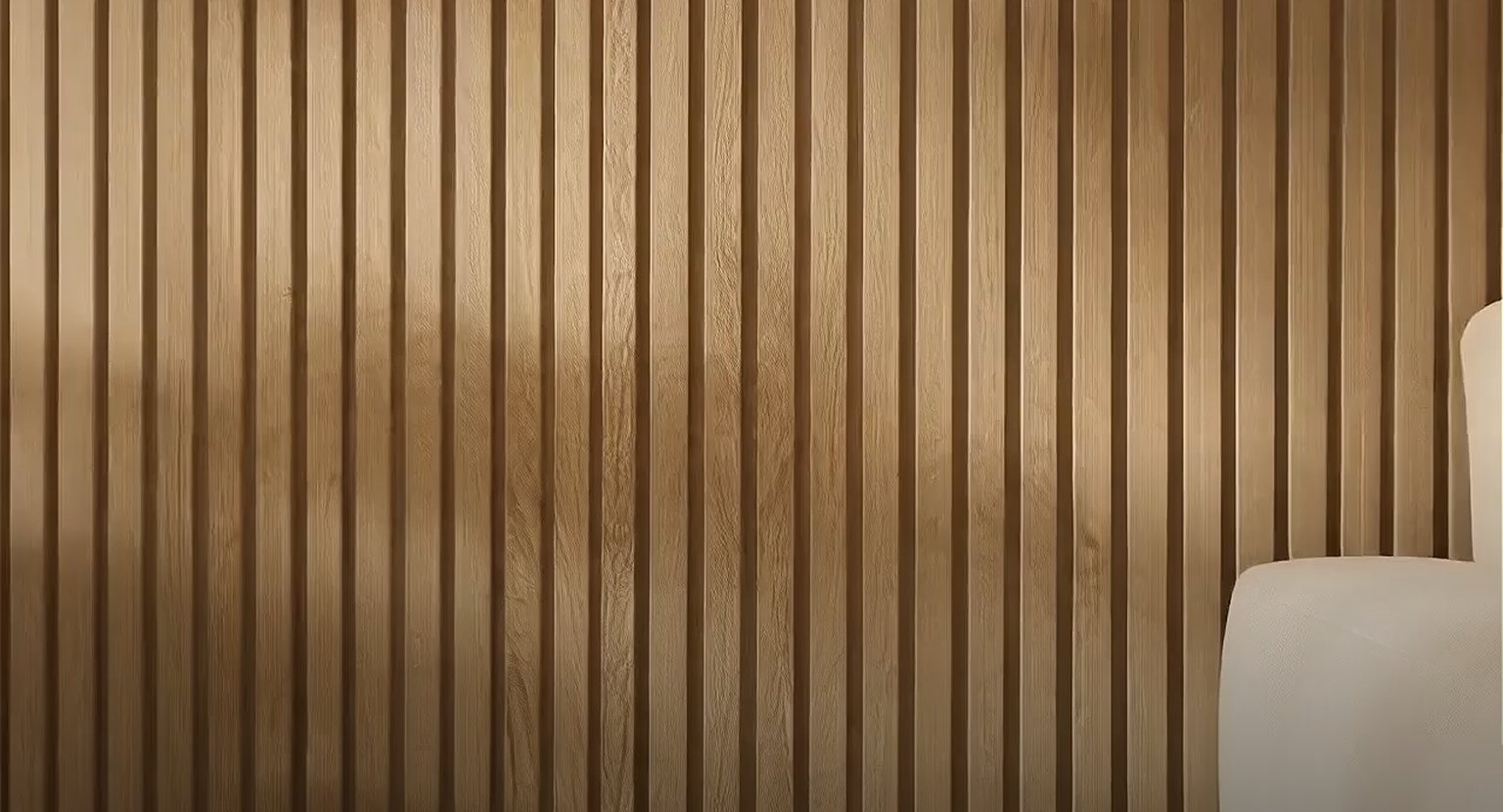 Vertical Akupanel acoustic wood slats form a textured wall; the edge of a white chair appears in the lower right corner, adding visual contrast.