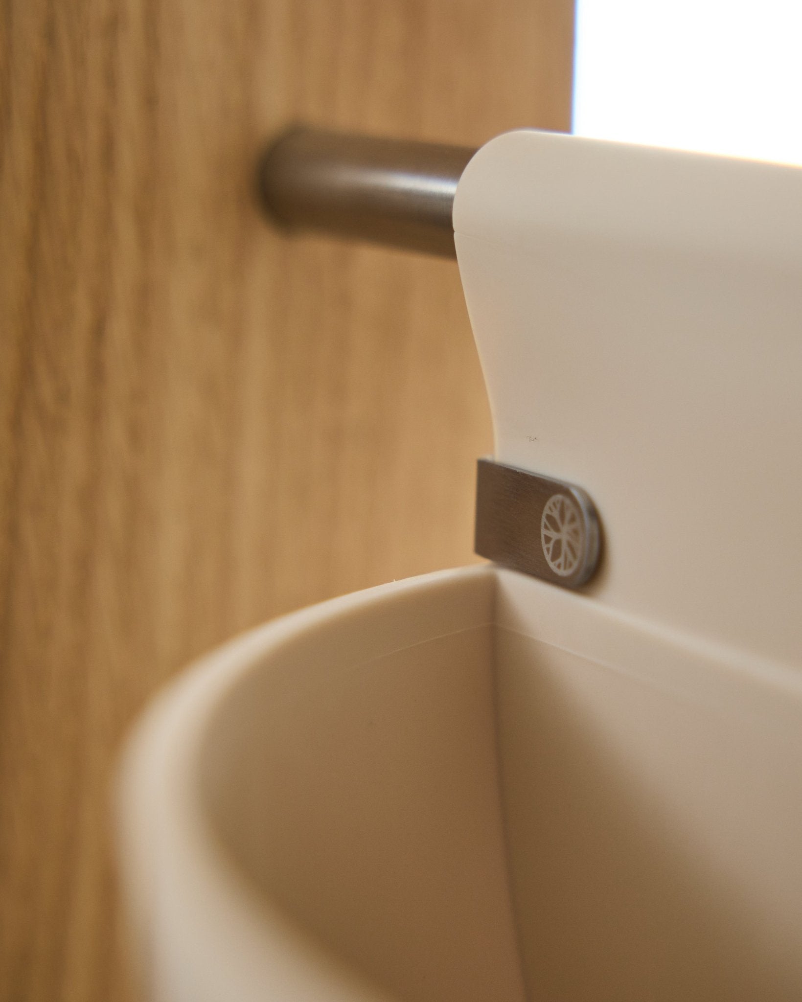 Nærbillede af Gro | Soft Pocket / BM2 (4 l) i lys beige fra WoodUpp, hængende på en metalstang monteret på træ; sløret baggrund. Nordisk akustiktilbehør.